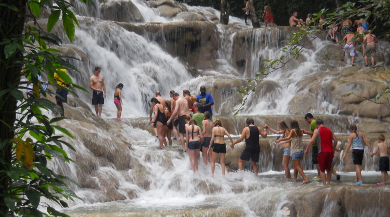 tourists climbing the dunns river fall